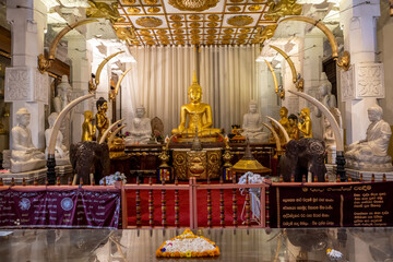 Sri Lanka. The city of Kandy. Attraction Temple of the Tooth of the Buddha. View of the Buddha statue. - obrazy, fototapety, plakaty