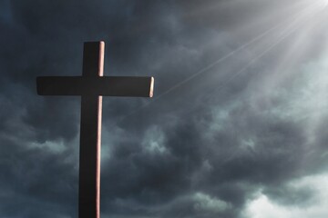 Dramatic religious church cross framed against a moody sky