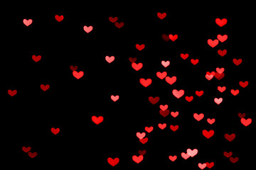 Fototapeta na wymiar Bokeh red lights isolated on black background. Heart-shaped, love concept, Valentine's Day, February 14