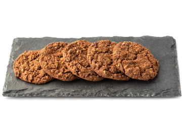 Row of granola cookies on a stone board for serving.