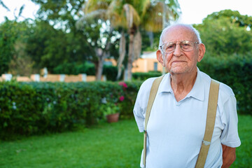 Elderly eighty year old man outdoors in a home setting