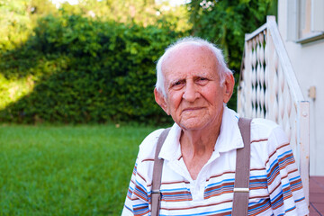 Elderly eighty year old man outdoors in a home setting - 480038983