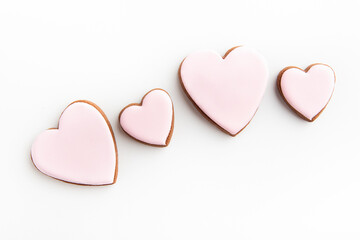 White cookies in shape of heart on white backgroun Mothers day. Womans day. Valentines Day