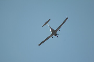Private white plane takes off from the airport against the backdrop of a clear sky during the day