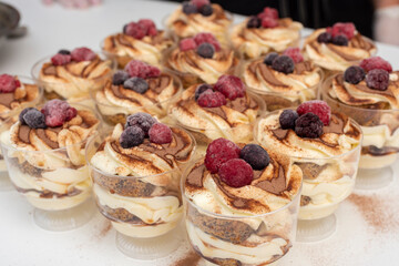 step by step preparation of sweet dessert with vanilla cream and cookies with cinnamon and red berries,