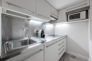 Small kitchen with stainless steel worktop in vacation rental apartment