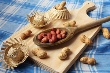 Peanuts in a wooden spoon with straw hats. June Party Brazil.