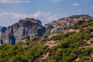 Fototapeta na wymiar Beautiful landscape of Meteor mountain with rock formations and religious stone monastery on top of a cliff in summer holiday, Kalabaka, Greece.