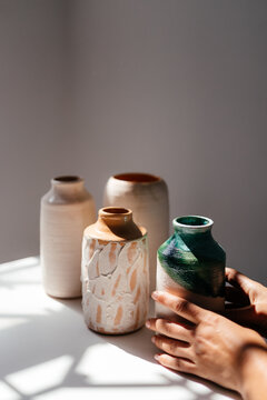 minimalist handmade clay vases on a white background with daylight