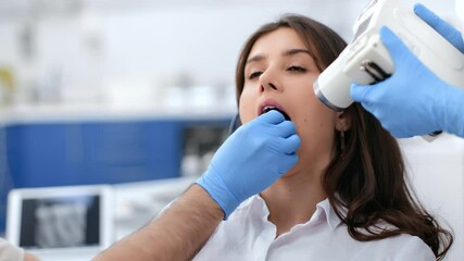 Male dentist x ray image of female patient oral cavity tooth checkup use roentgenogram device 