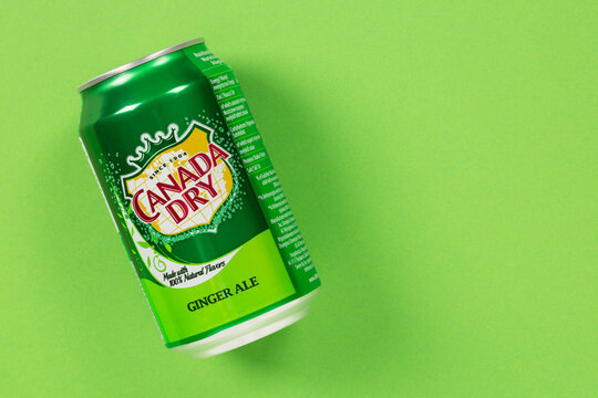 Ternopil, Ukraine - January 10, 2022: Can of Canada Dry Ginger Ale drink on a green background with copy space