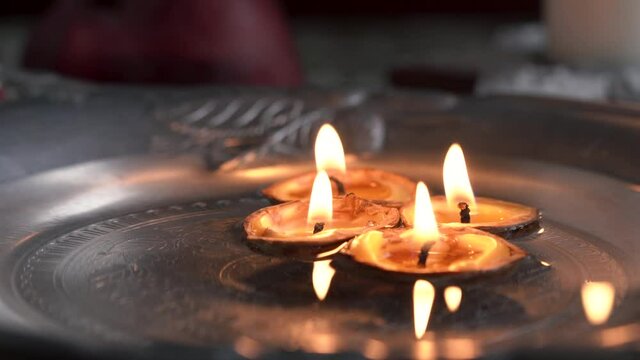 Christmas candles made from nutshells and bee wax floating in water