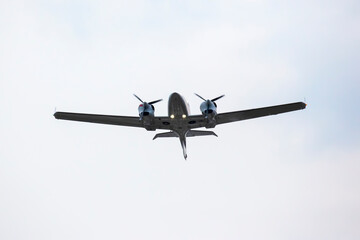 twin-engine light aircraft flying in the sky