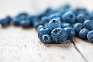 Fresh blueberries on wooden background close-up copy space