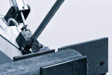The  band saw for industrial cutting  the metal rod and using the coolant in light blue scene....