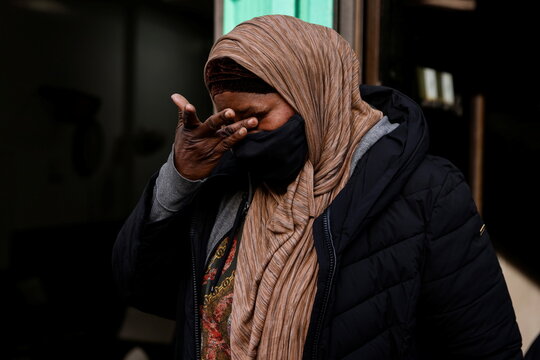 A woman leaves the Timbuktu Islamic Center after the funeral for two of the victims of the Bronx multi-level apartment building fire in Manhattan borough of New York
