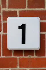 House number one on a brick wall