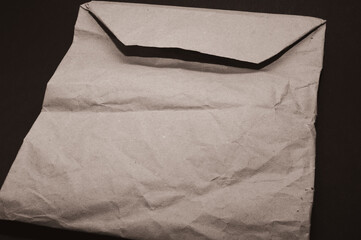 paper bag, envelope, crumpled insulated on a black background