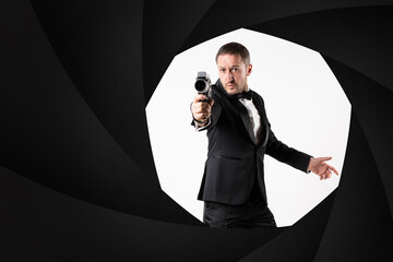 A parody of James Bond, a man wearing a tuxedo handling a Super 8 camera in a classic 007 pose, shooting at camera..