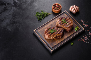 Fototapeta na wymiar Fresh juicy delicious beef steak on a dark background