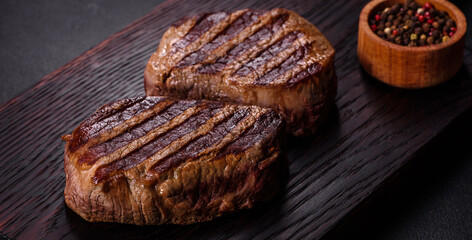 Fresh juicy delicious beef steak on a dark background