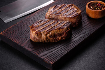 Fresh juicy delicious beef steak on a dark background
