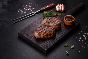 Fresh juicy delicious beef steak on a dark background