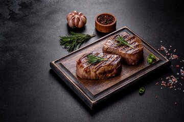 Fototapeta na wymiar Fresh juicy delicious beef steak on a dark background