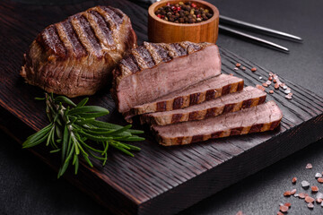 Fresh juicy delicious beef steak on a dark background