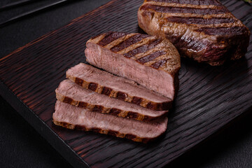 Fresh juicy delicious beef steak on a dark background