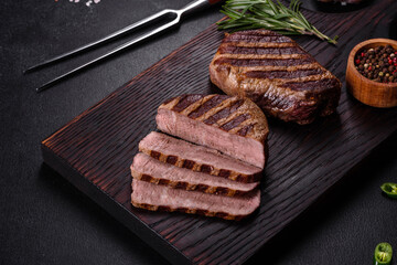 Fresh juicy delicious beef steak on a dark background