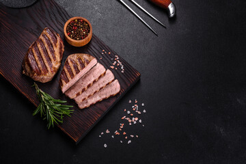 Fresh juicy delicious beef steak on a dark background