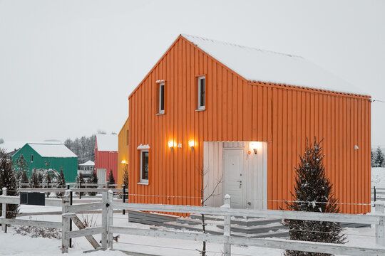 Modern wood house in the Scandinavian style with different color , winter day in village