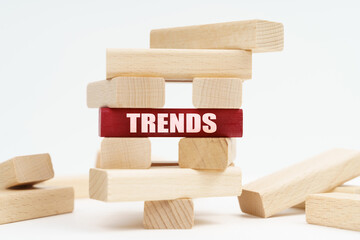 On the white surface there is a ruined tower made of planks, on a red plaque there is an inscription - Trends