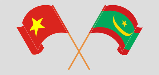 Crossed and waving flags of Vietnam and Mauritania