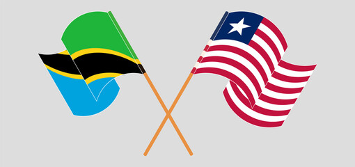 Crossed and waving flags of Tanzania and Liberia