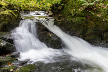Fototapeta na wymiar Long exposure of a waterfall on the East Lyn River at Watersmeet in Exmoor National Park