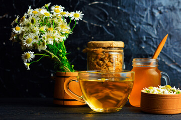 cup of herbal chamomile tea and daisy flowers. doctor treatment and prevention of immune concept, medicine - folk, alternative, complementary, traditional medicine
