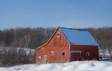 Old barn in a winter countryside landscape in Quebec, Canada