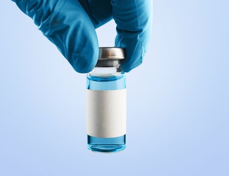 Glass medical bottle of pain medication in doctor hands