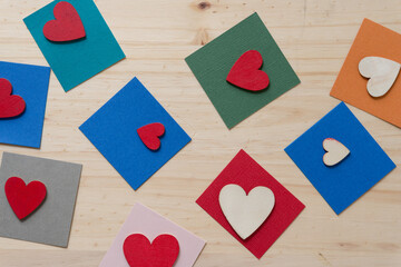 grungy wooden hearts on paper squares and wood