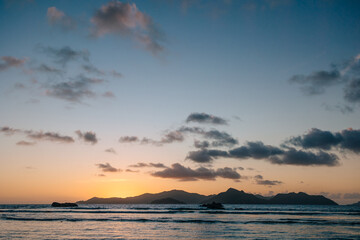 Obraz premium Calm sea with sunset sky and sun through the clouds over. Meditation ocean and sky background. Tranquil seascape. Horizon over the water.