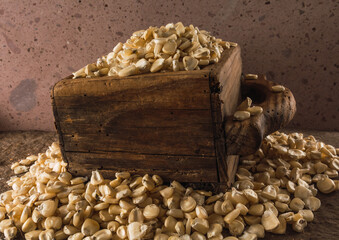 Typical Mexican white corn on a wooden panel, a traditional measure in Central and South America to calculate the grains.