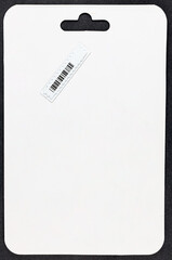 Radio frequency (RFID) and bar code identification security label on a white price and package tag for anti-shoplifting