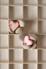 grungy wooden hearts on the rocks (in a box)