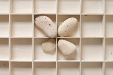 objects found on an urban beach and a wooden box with square spaces