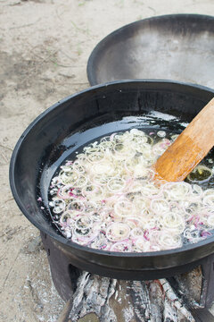 Onions Being Fried In A Large Pot Of Oil, Community Cooking In The Open, Making Nigerian Stew