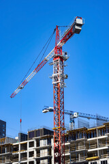 Fototapeta na wymiar Tower crane on the construction site of the residential apartment building 