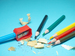 School supplies. Pencil sharpening. Pencil sharpener . Multicolored pencils.   The process of...