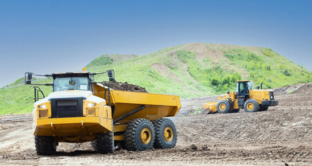 Wheel loader and dump truck on the construction site